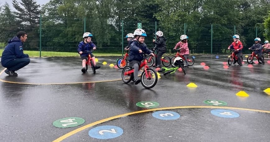A group of young children on bicycles 