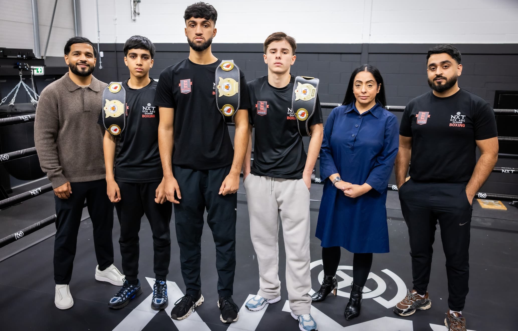 Cllr Arooj Shah standing in a boxing ring with representatives from NxtGen Boxing