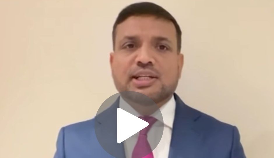 Cllr Mohon Ali speaking in a smart navy suit