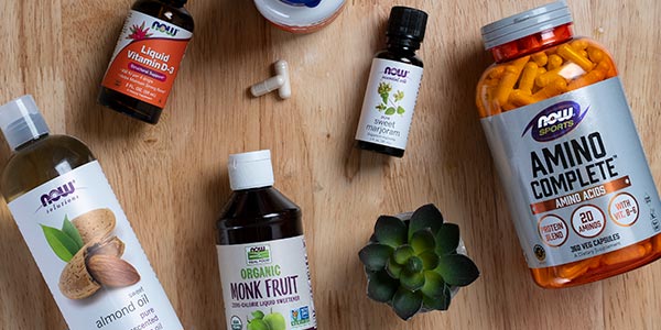 Group of NOW products including Almond Oil, Monk Fruit, Amino Complete, Sweet Marjoram oil and Liquid Vitamin D-3 