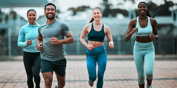 Diverse group of men and women running together