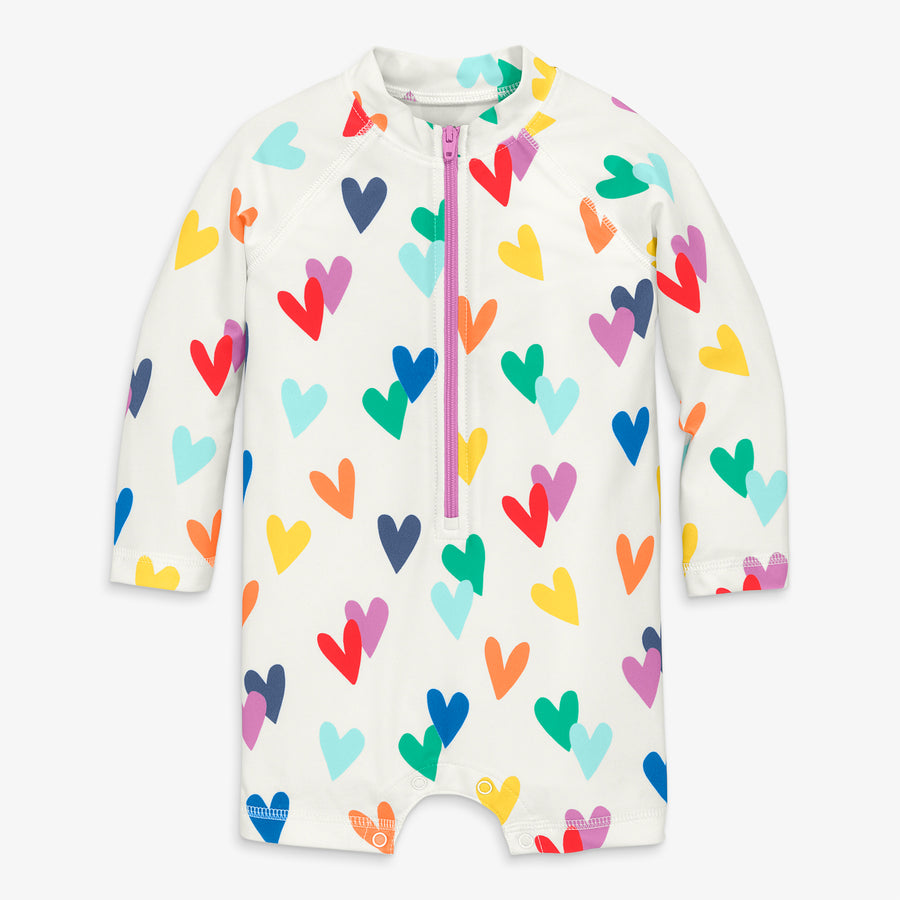 Baby one-piece rash guard in rainbow confetti hearts