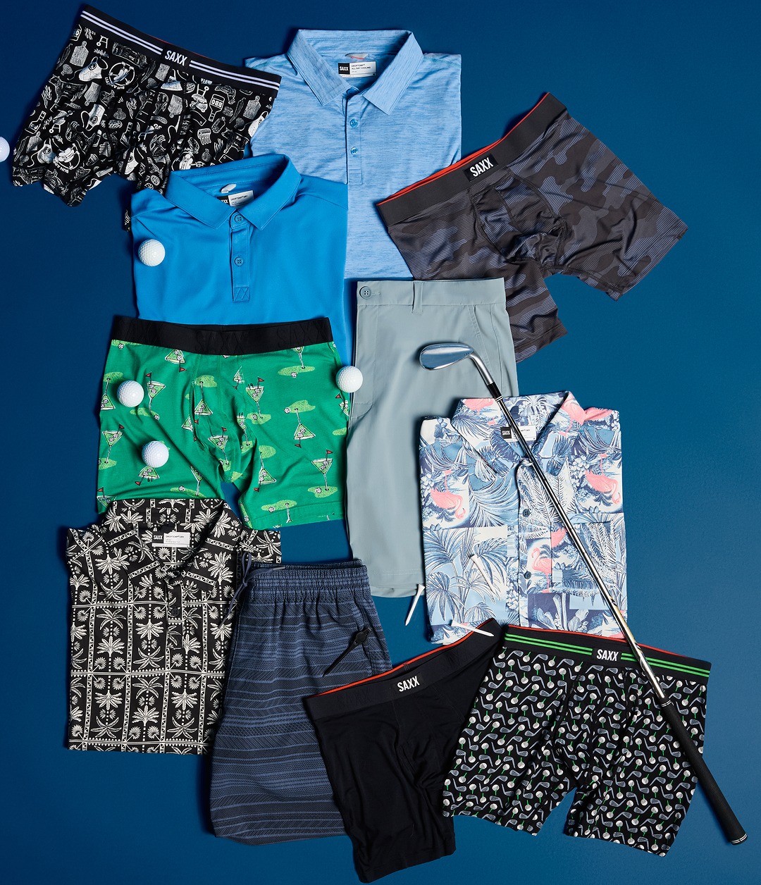 Flat lay of SAXX golf apparel and underwear assortment featuring polos, shorts, printed boxers, and golf accessories.