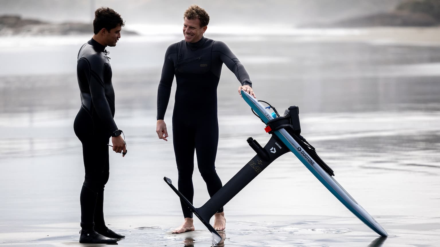 an image of two man standing besides the Foil Assist talking about it