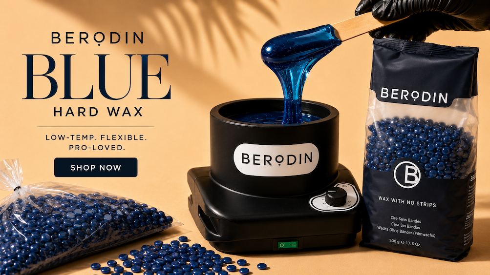 Gold background with Berodin blue wax prominentialy featured. There is a bulk bag of blue beads, some blue beads scattered on the table, a black wax warmer with melted blue wax in it, a hand holding a waxing applicator, pulling a glob of wax from the warmer, and a 2.2lb bag of Berodin Wax. The image says "Berodin Blue Hard Wax. Low-temp, flexible, pro-loved"