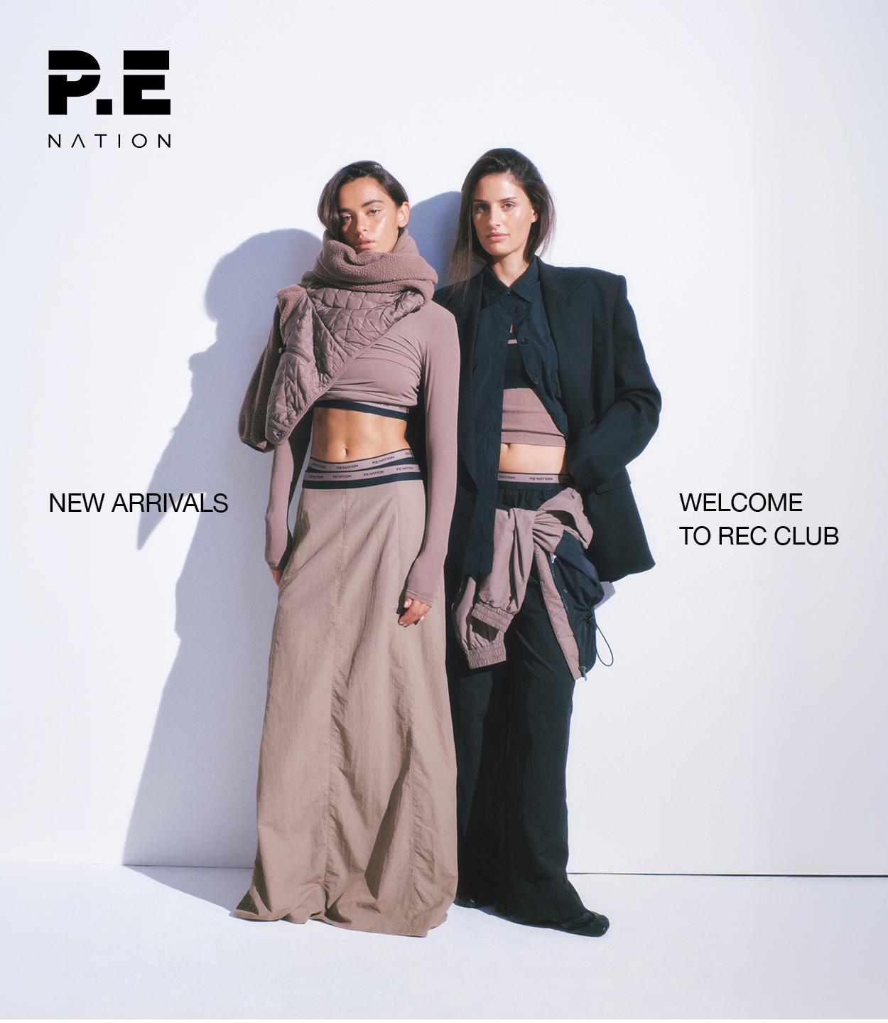 Studio shot of two woman wearing neutral P.E Nation outfits.