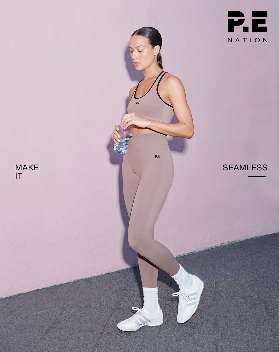 Brunette woman wearing a brown P.E Nation Seamless Sports Bra and Leggings.