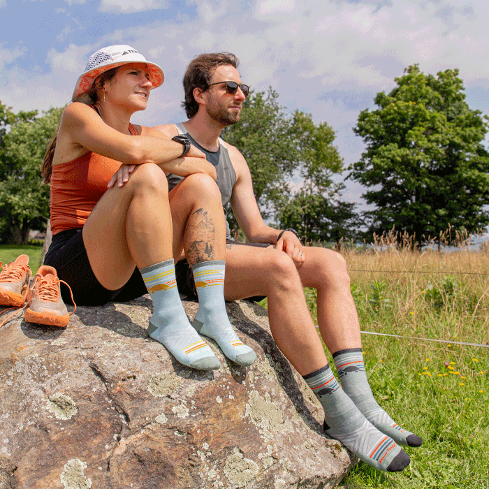 Shop New Run Socks - two runners hang on a sunny rock in their Pacer socks