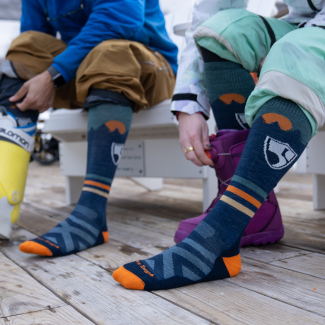 Shop High Fives socks - a skier and snowboarder wearing navy striped socks