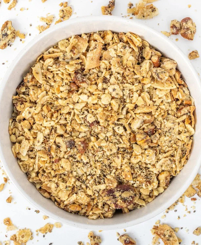 Bowl of crisp superfood granola made with nuts, seeds, and coconut. Fearrington Village.