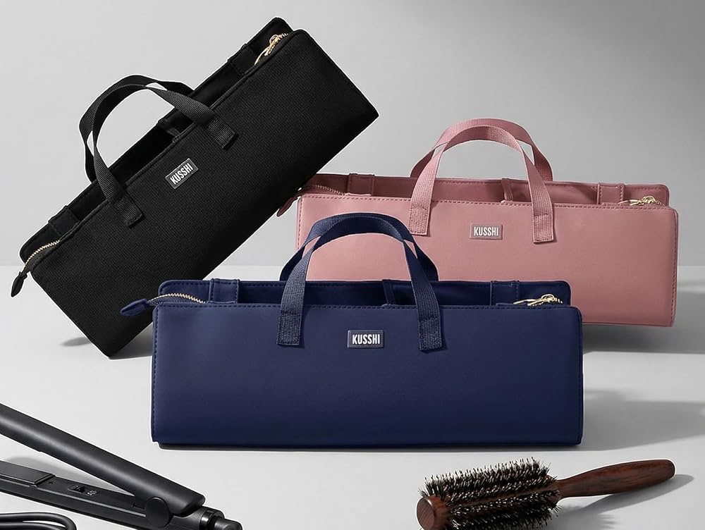 Collection of structured travel beauty organizers in black, blush pink, and navy blue, designed to store hair styling tools and accessories with carrying handles and zippered compartments.