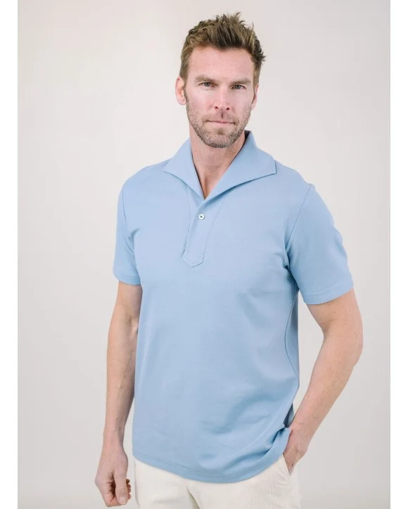 Man wearing a light blue knit polo shirt with a relaxed open collar. Fearrington Village.