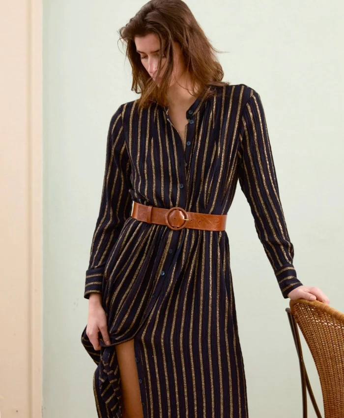 Woman wearing a navy striped shirt dress with a tan belt. Fearrington Village.