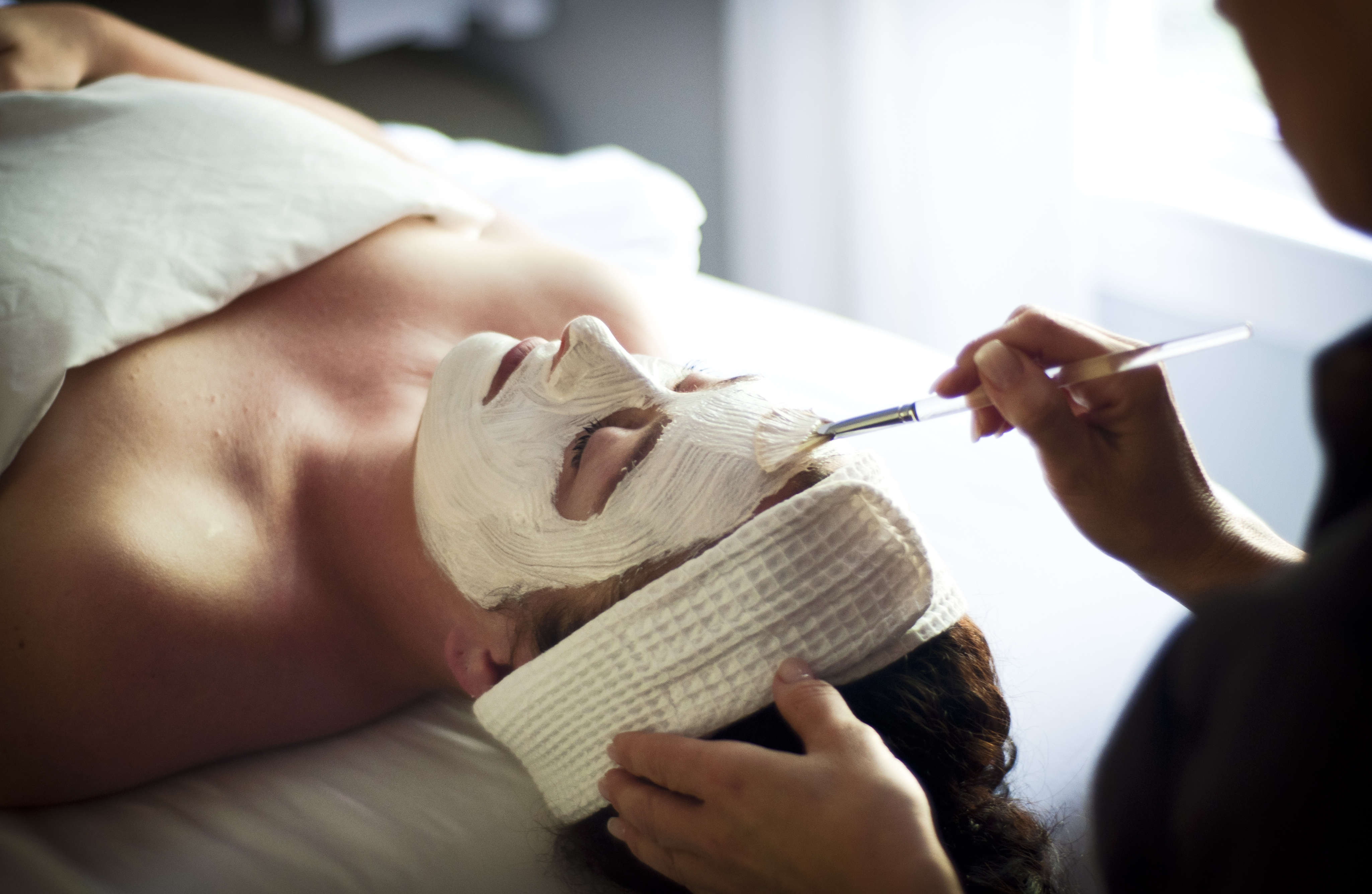 Person receiving a relaxing facial with a nourishing mask applied by a spa esthetician. Fearrington Village.
