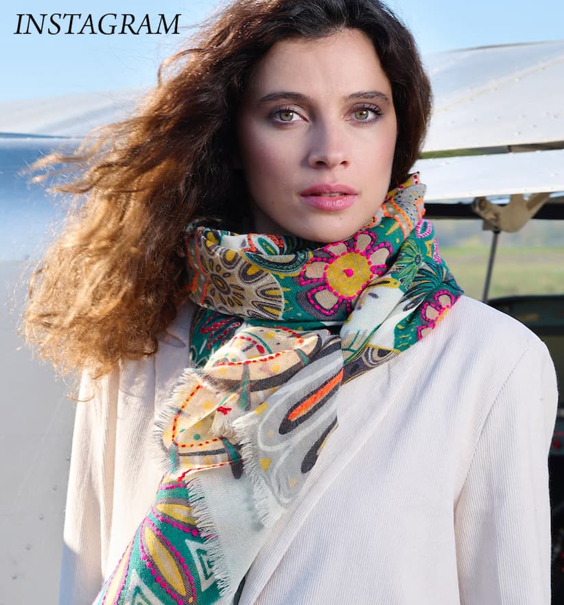 An image of a woman with a scarf on standing in front of a plane