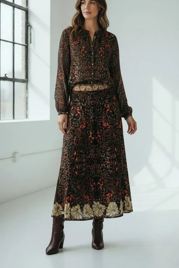 Woman wearing a dark floral blouse with a matching long skirt and brown ankle boots. Fearrington Village.