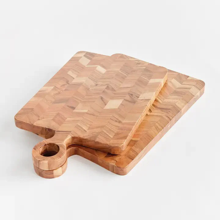 Two stacked wooden cutting boards with a geometric end-grain pattern and a circular handle detail.