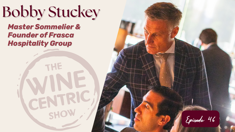 Promotional graphic for The Wine Centric Show featuring Bobby Stuckey, Master Sommelier and founder of Frasca Hospitality Group. A photograph shows Stuckey in a blue plaid jacket and tie, engaged in conversation in a restaurant setting. The graphic includes the Wine Centric Show logo and identifies the feature as Episode 46.