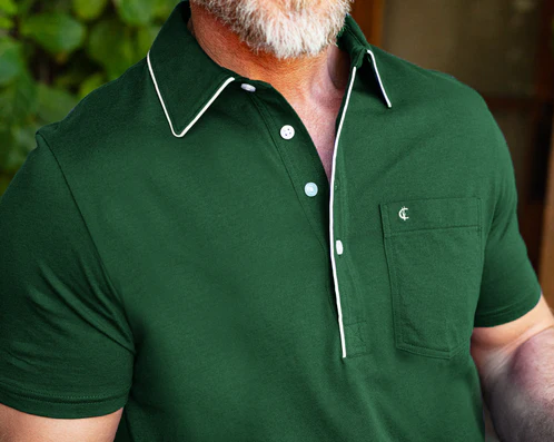 Close-up of a man wearing a dark green polo shirt with white trim and a chest pocket, showing the textured fabric and collar detail.