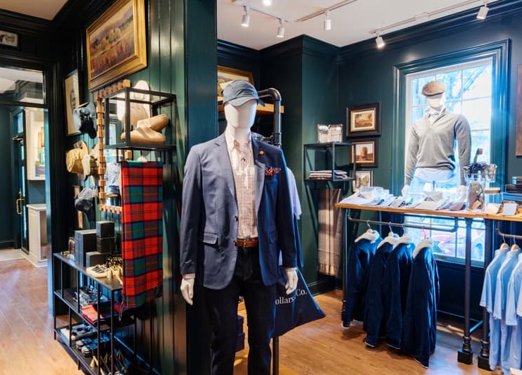 Men’s clothing and accessories displayed in a richly appointed shop, with tailored jackets, shirts and casual sportswear. Fearrington Village.