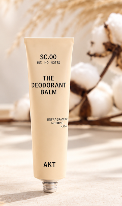 AKT unfragranced Deodorant Balm displayed with cotton and dried grasses in a bright, neutral setting. Fearrington Village.