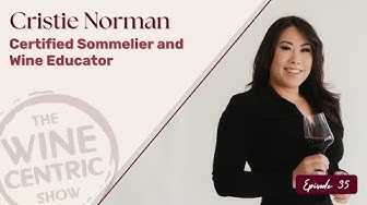 Promotional graphic featuring Cristie Norman, a certified sommelier and wine educator, standing against a light background and holding a glass of red wine. Text reads “Cristie Norman, Certified Sommelier and Wine Educator,” with “The Wine Centric Show” logo and “Episode 35” noted on the image.