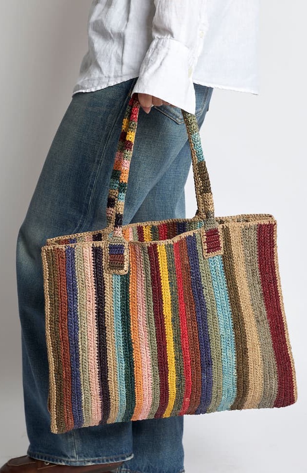 Handcrafted from natural raffia and woven with vibrant multicolored stripes, this roomy tote brings effortless style to everyday outings. Lightweight yet durable, it offers plenty of space for market finds, beach essentials, or daily necessities, while the rich mix of colors pairs beautifully with everything from denim to summer linens. A versatile carryall that adds texture, personality, and artisan charm wherever you go.