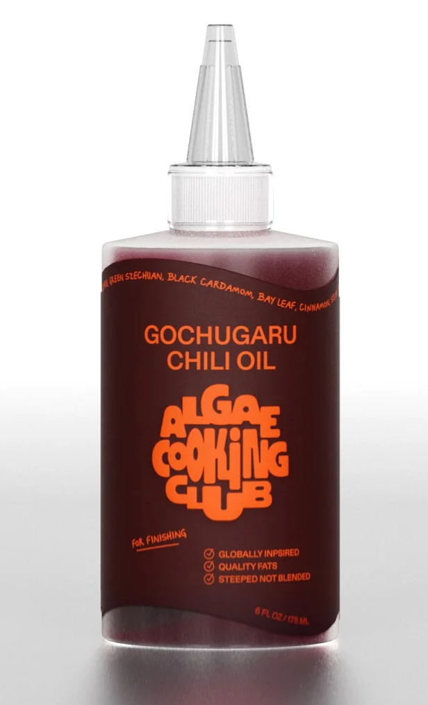 Bottle of Gochugaru Chili Oil in a squeeze bottle with a precision tip, featuring bold orange lettering on a dark label for a modern, minimalist look.