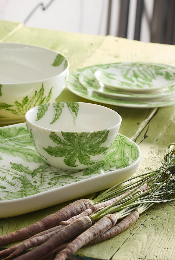Bottle of Le Grillon Côtes-du-Rhône wine displayed on a counter with shelves of assorted wine bottles in the background.