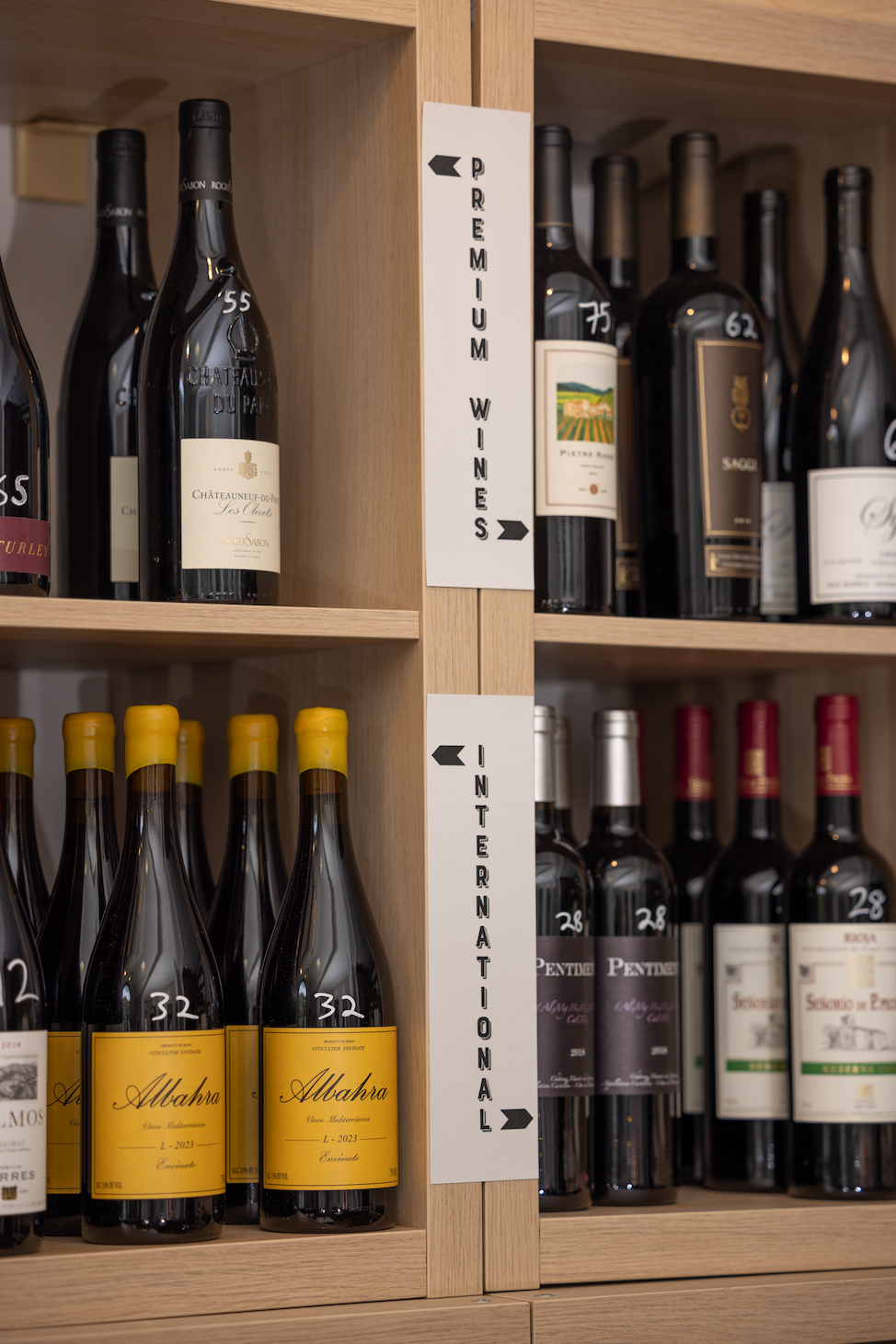 Premium and international wines displayed on oak shelves at Galloway's Wine Bar, Fearrington Village.