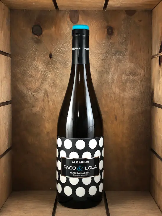 Bottle of Paco & Lola Albariño white wine with its signature black-and-white polka dot label. Fearrington Village.