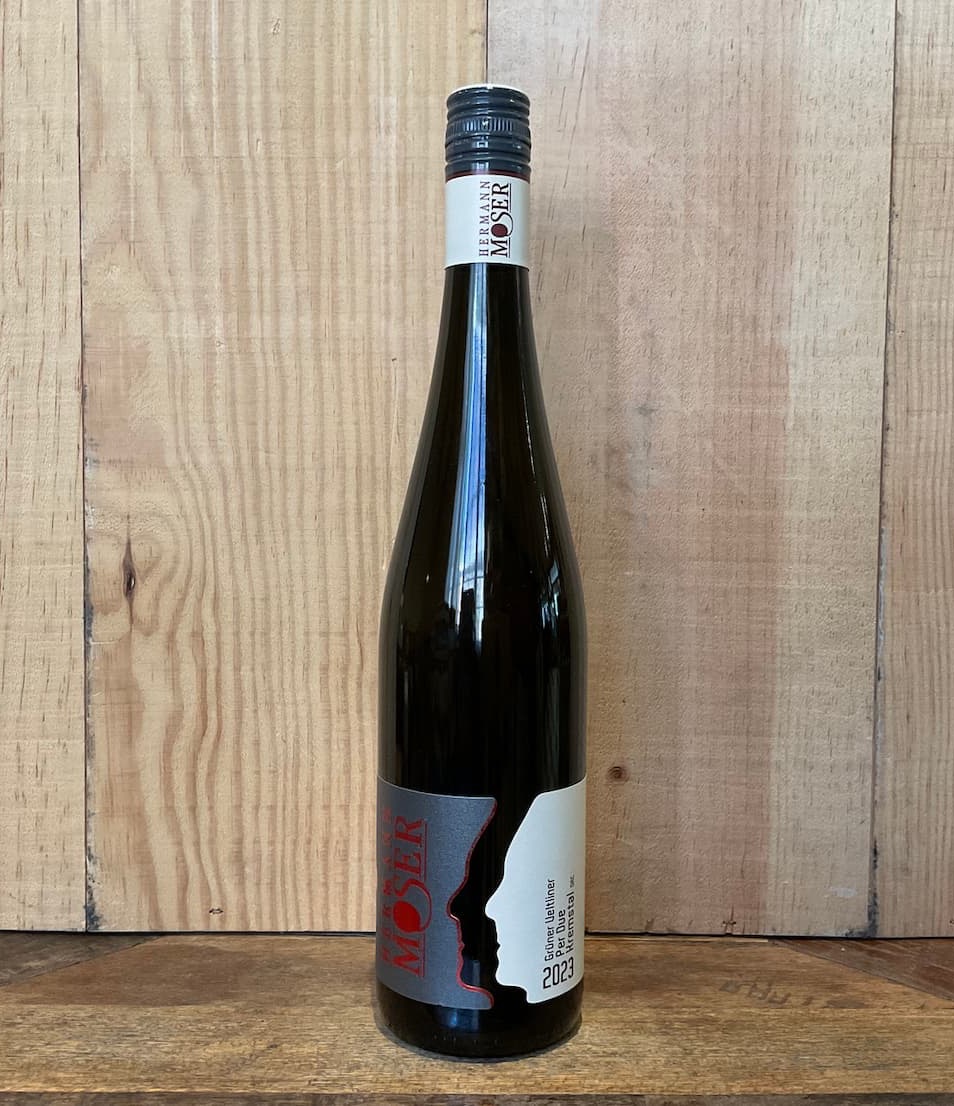 Bottle of Weingut Moser 2023 Grüner Veltliner Kremstal wine displayed against a natural wood backdrop. Fearrington Village.