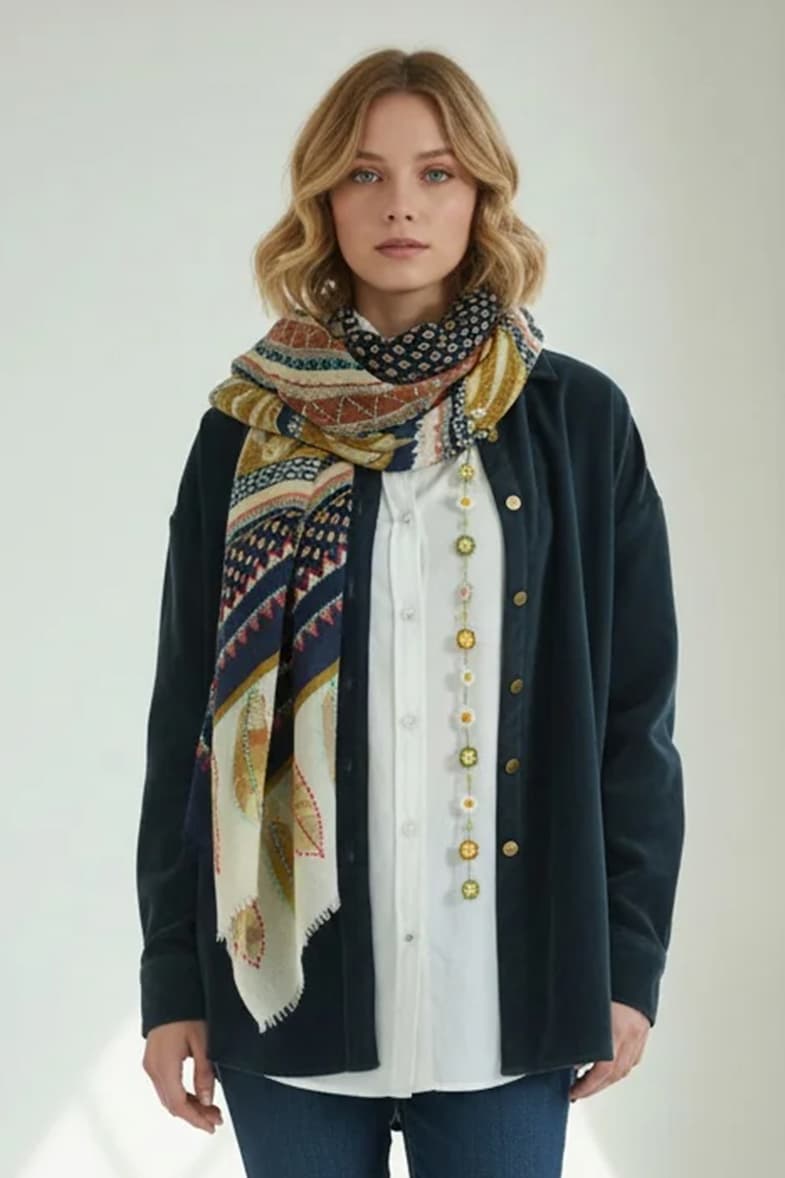 Woman wearing a colorful patterned scarf with a navy jacket and white blouse. Fearrington Village.