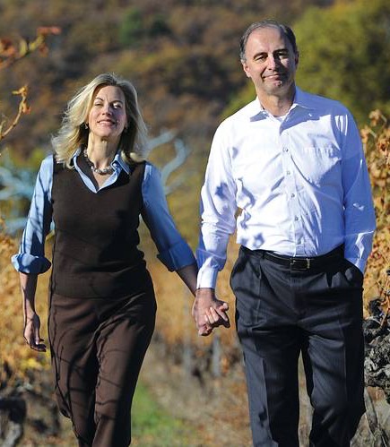A couple walking hand in hand through a vineyard on a sunny autumn day. Fearrington Village.