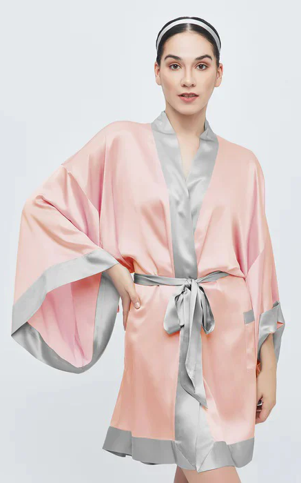 Woman wearing a blush satin spa robe with silver trim and matching headband. Fearrington Village.