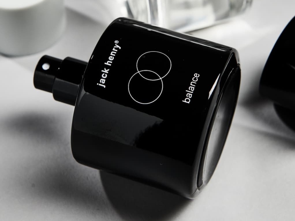 Black Jack Henry “Balance” fragrance bottle with spray nozzle, shown on its side on a white surface.