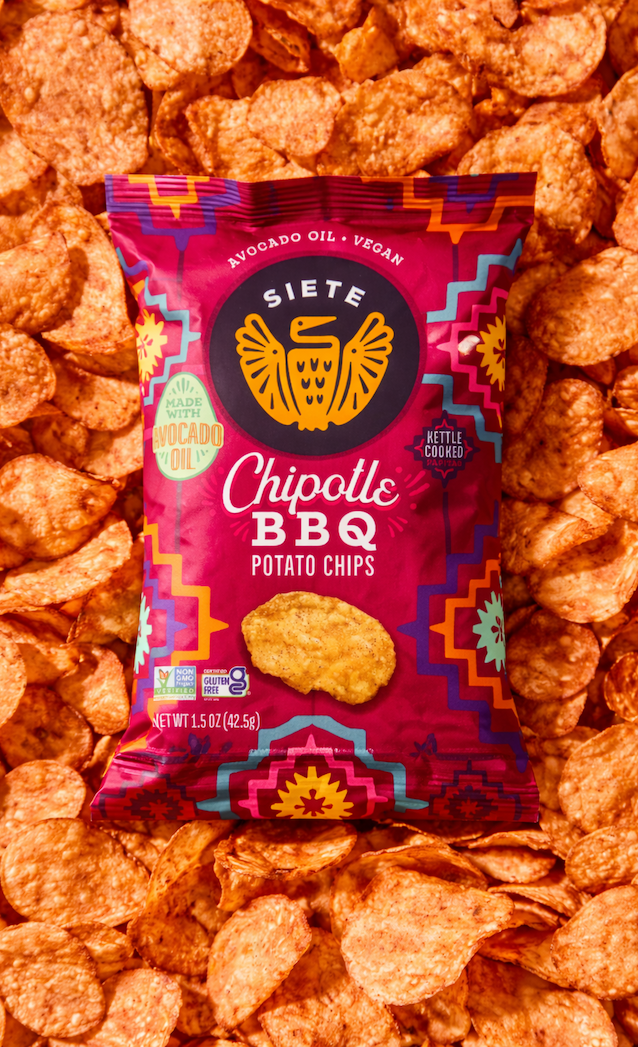 Bag of Siete Chipotle BBQ potato chips, kettle-cooked and made with avocado oil, shown on a background of scattered chips.