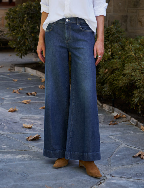 Dark-wash wide-leg jeans paired with a white shirt and brown suede ankle boots. Fearrington Village.