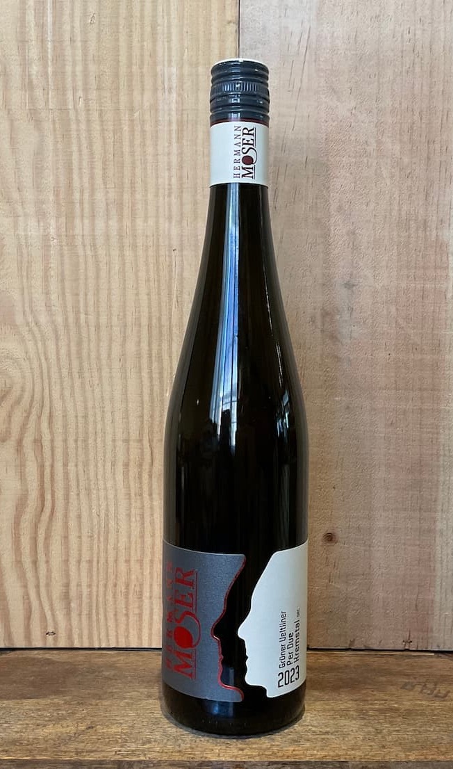 Bottle of 2023 Hermann Moser Grüner Veltliner Kremse wine displayed against a rustic wood backdrop. Available at Galloway's Wine Bar at Fearrington Village.