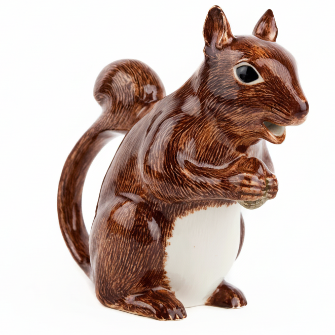 Ceramic squirrel figurine holding a nut, with a white belly and brown fur details.