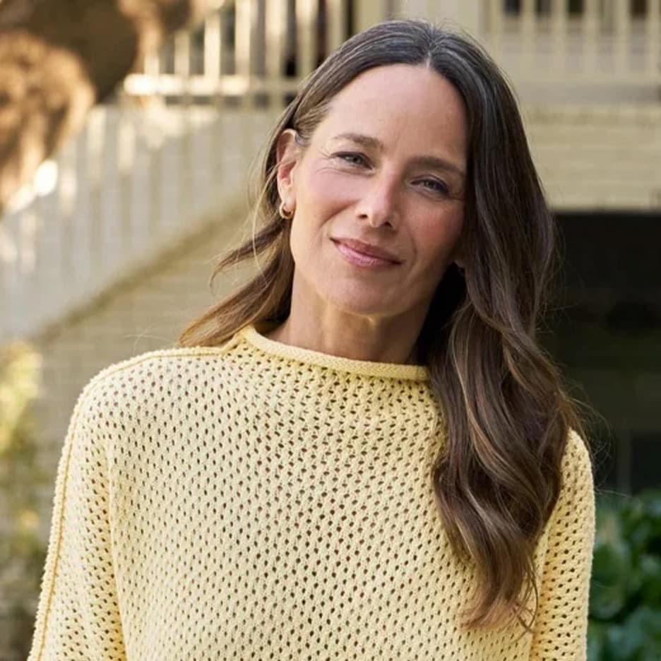 Woman wearing a lightweight yellow open-knit sweater outdoors, Fearrington Village.