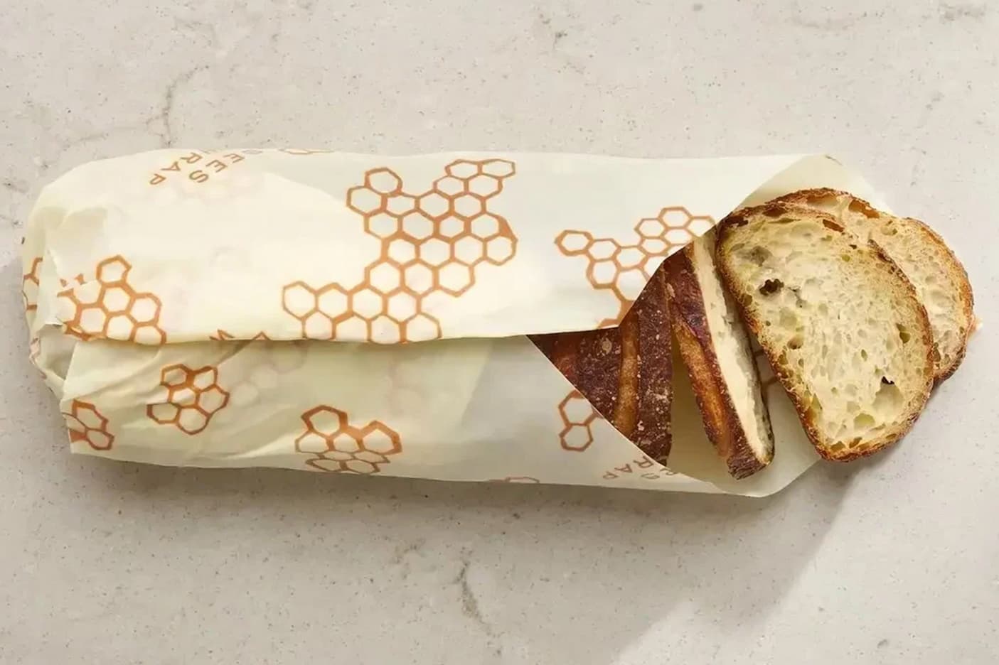 Sliced sourdough loaf stored in reusable honeycomb-patterned beeswax wrap. Fearrington Village.