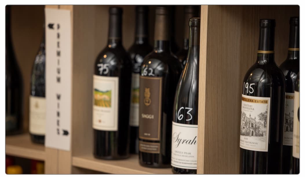 Shelves of assorted wine bottles with handwritten price tags are displayed for sale at Galloway’s Wine Shop. Fearrington Village