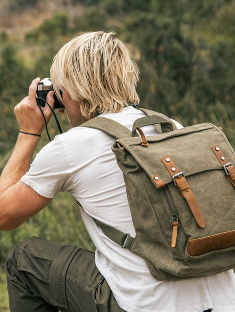 Person photographing nature while wearing a canvas backpack. Fearrington Village.