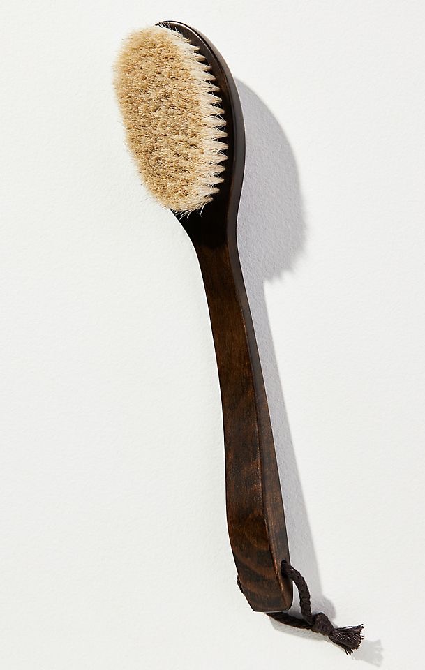 Long-handled wooden bath brush with natural bristles for gentle exfoliation and body care, photographed against a clean white background. Fearrington Village.