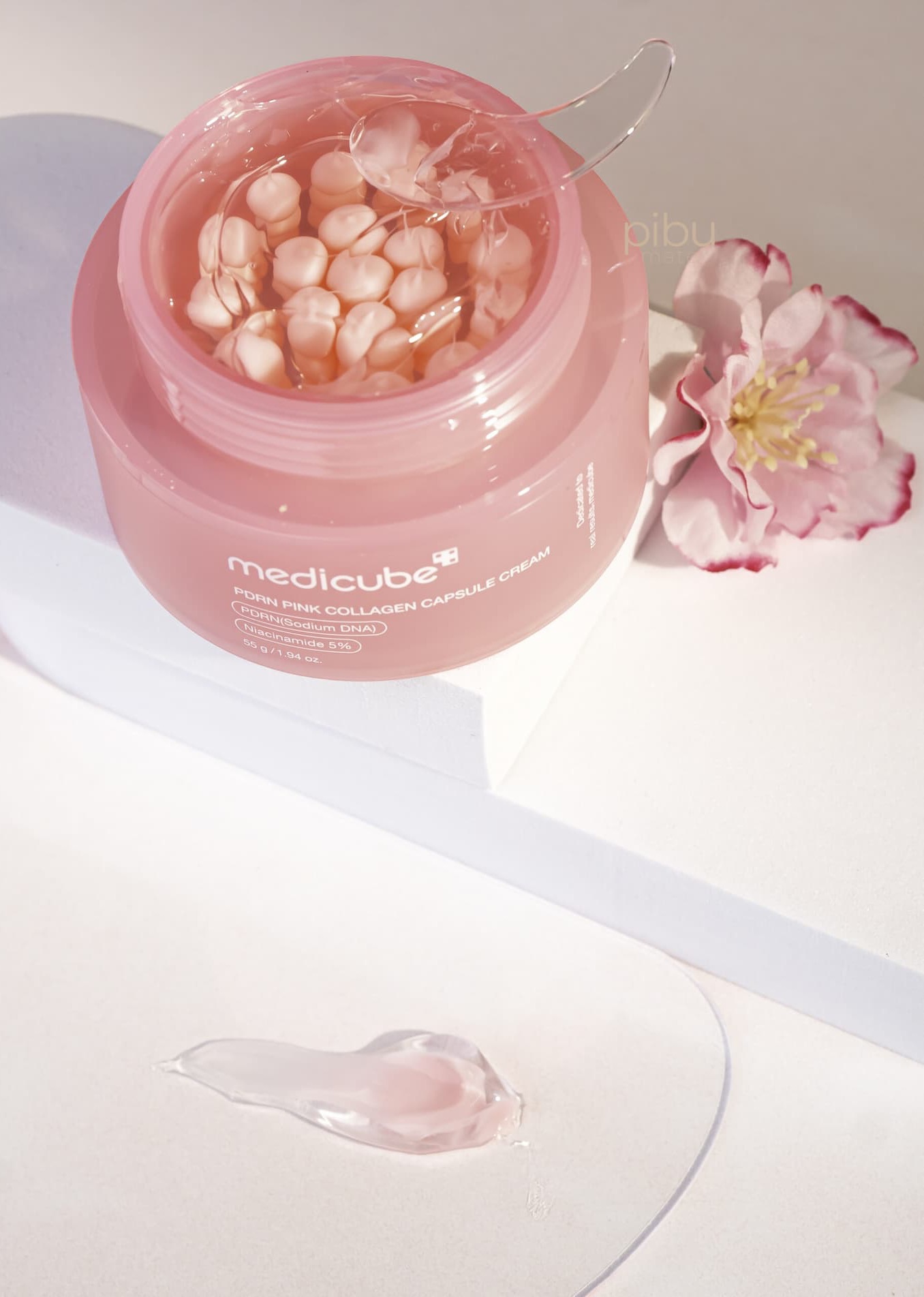 Medicube PDRN Pink Collagen Capsule Cream in a pink jar with a clear applicator and floral accent. Fearrington Village.