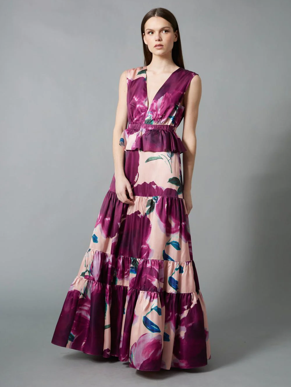Woman wearing a sleeveless floral maxi dress in rich plum and blush tones with a tiered skirt. Fearrington Village.