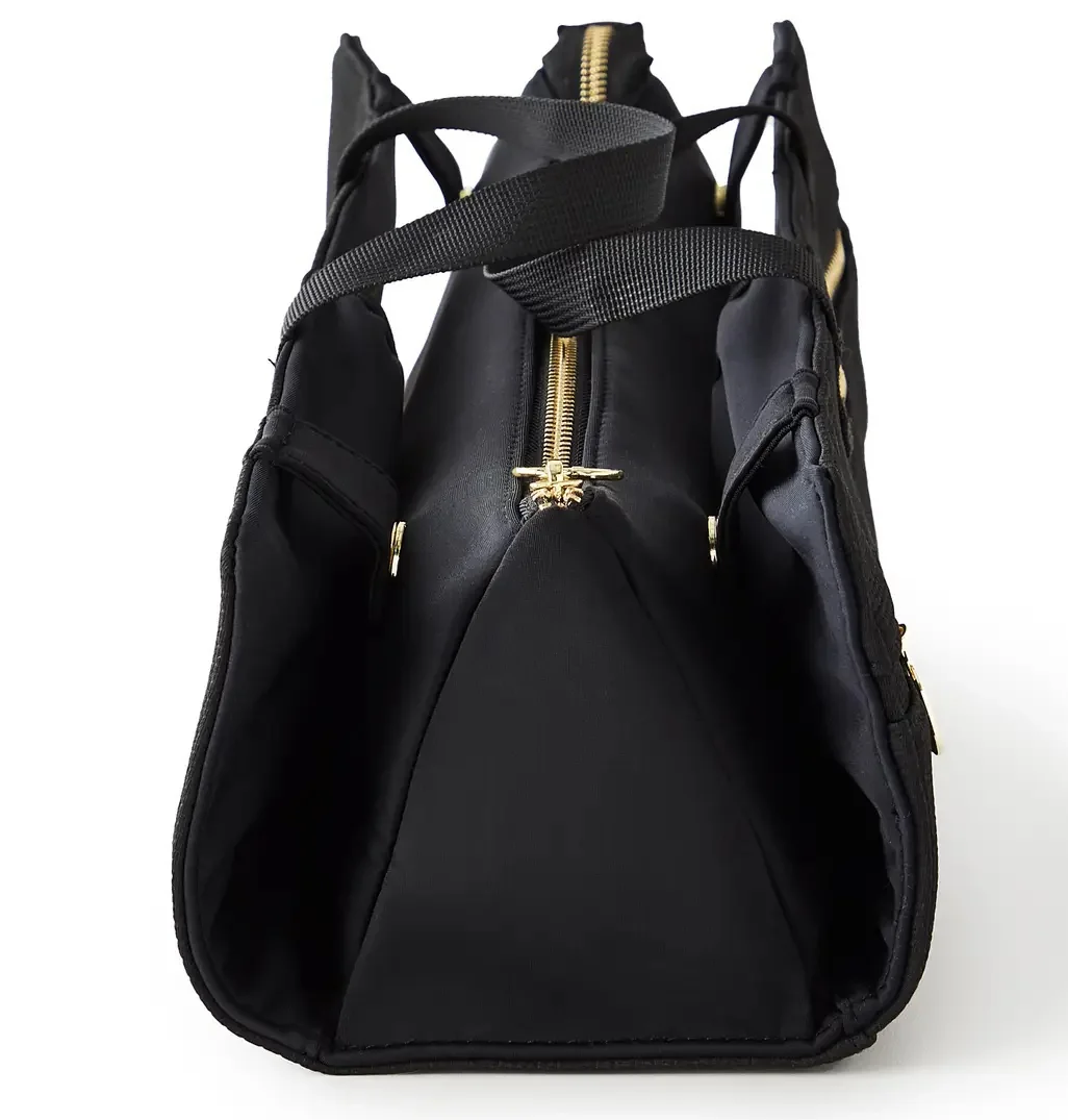 Structured black travel organizer bag with gold zipper detailing, side storage pockets, and carrying handles, shown against a white background.