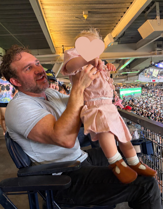 Holding my daughter at the Yankees v. Dodgers game