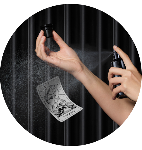 ARgENTUM's BECOME eau de parfum being sprayed onto the wrist with the BECOME archetype card below